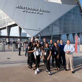 group of winners stand outside the Mercedes-Benz stadium